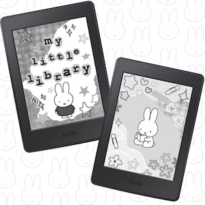 May include: Two black Kindle e-readers with white and grey illustrations. One shows the text "my little library" with a bunny character and star shapes. The other displays a bunny reading a book with floral and star designs.