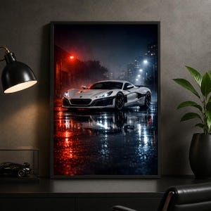 May include: A framed wall art print depicting a white sports car parked on a wet city street at night. The scene features reflections of red and white street lights on the rain-slicked pavement, with a dark urban skyline visible in the background.