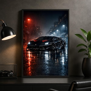 May include: A framed wall art print depicting a black sports car parked on a wet city street at night. The scene features rain, glowing red and white street lights, and blurred urban buildings in the background, creating a dark, moody atmosphere.