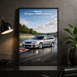 May include: A framed wall poster featuring a silver Nissan Stagea 260RS Autech on a wet racetrack. The text reads Nissan Stagea 260RS Autech, Track-Inspired, Track Heritage Collection, and 1998 Track Heritage Series against a blue sky background.