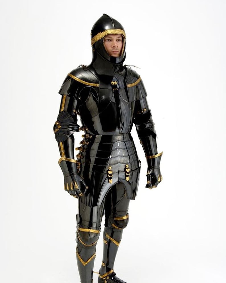 May include: A full suit of black armor with gold accents. The armor includes a helmet, chest plate, arm and leg protection, and gloves. The armor is highly polished, reflecting the light. The gold trim adds a decorative element to the medieval-style armor.