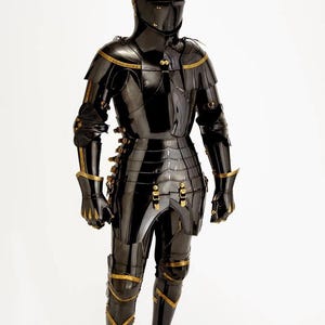 May include: A full suit of black armor with gold accents, including a helmet, chest plate, and leg guards. The armor is highly polished, reflecting light, and features intricate detailing. The medieval-style armor is designed for protection and display.