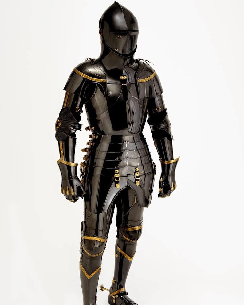 May include: A full suit of black armor with gold accents, including a helmet, chest plate, and leg guards. The armor is highly polished, reflecting light, and features intricate detailing. The medieval-style armor is designed for protection and display.