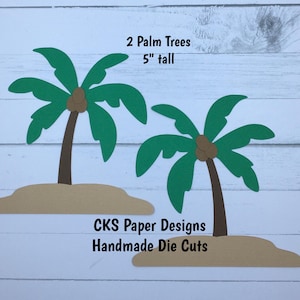 May include: Two handmade paper palm trees, each 5 inches tall, with green fronds, brown trunks, and tan islands. The text "CKS Paper Designs Handmade Die Cuts" is also visible.