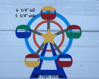 May include: A paper die cut of a Ferris wheel with six colorful cars. The Ferris wheel is 6 1/4 inches tall and 5 3/4 inches wide. The text "CKS Paper Designs Handmade Die Cuts" is at the bottom of the image.