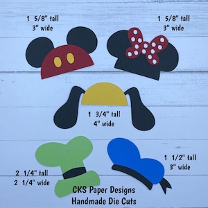 May include: Five die-cut paper shapes for crafting projects. The shapes include Mickey Mouse ears, Minnie Mouse ears, Pluto ears, a green hat with a black band, and a blue hat with a black band. The shapes are all different sizes and have measurements in inches.