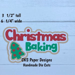 May include: A die cut for crafting, featuring the words "Christmas Baking" in red and green letters with a green Christmas tree with red ornaments. The die cut is 3 1/2 inches tall and 6 1/4 inches wide. The text "CKS Paper Designs Handmade Die Cuts" is also included.