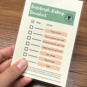 May include: A white and beige sourdough baking timesheet with a checklist for each step, including "feed starter" and "bake." The Maison Margot Boutique logo is in the upper right corner.