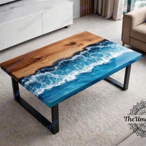 May include: A rectangular coffee table with a wooden top and a blue resin design resembling ocean waves. The table has a black metal frame. The top is a combination of natural wood and a glossy blue resin. The table is approximately 48 inches long and 24 inches wide.