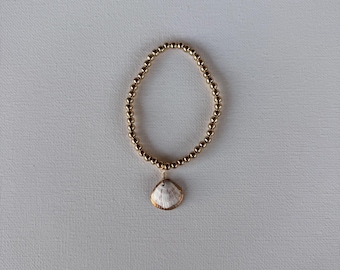 gold beaded bracelet with gold painted shell!! found and made by me!