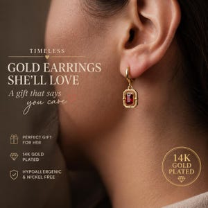 May include: Gold earrings with a rectangular red gemstone set in a gold frame. The earrings are attached to a gold hoop. The text on the image says "Gold Earrings She'll Love" and "14K Gold Plated".