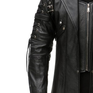 May include: A black jacket featuring a long-sleeve design with decorative lace-up detailing along the outer arm, silver-toned metal buckles, and studs. The garment includes a front zipper closure and a structured collar with visible seams.