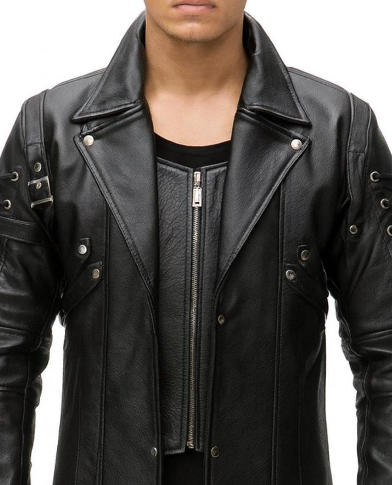 May include: Black leather jacket with a notched collar, a zip-up front, and decorative metal accents. The jacket features a layered design with a second layer visible beneath the main jacket. The sleeves have decorative details.