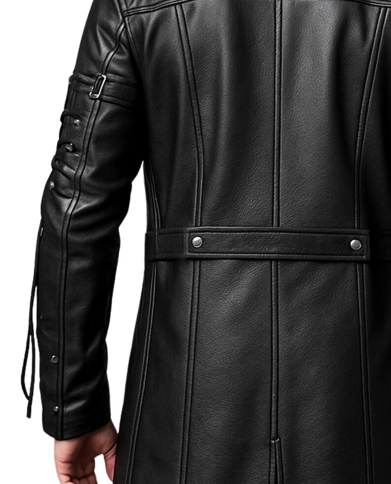 May include: A black leather jacket featuring vertical seam detailing, a horizontal waist strap with two silver-toned metal snaps, and a sleeve design with a buckled strap and multiple silver-toned studs along the outer arm.