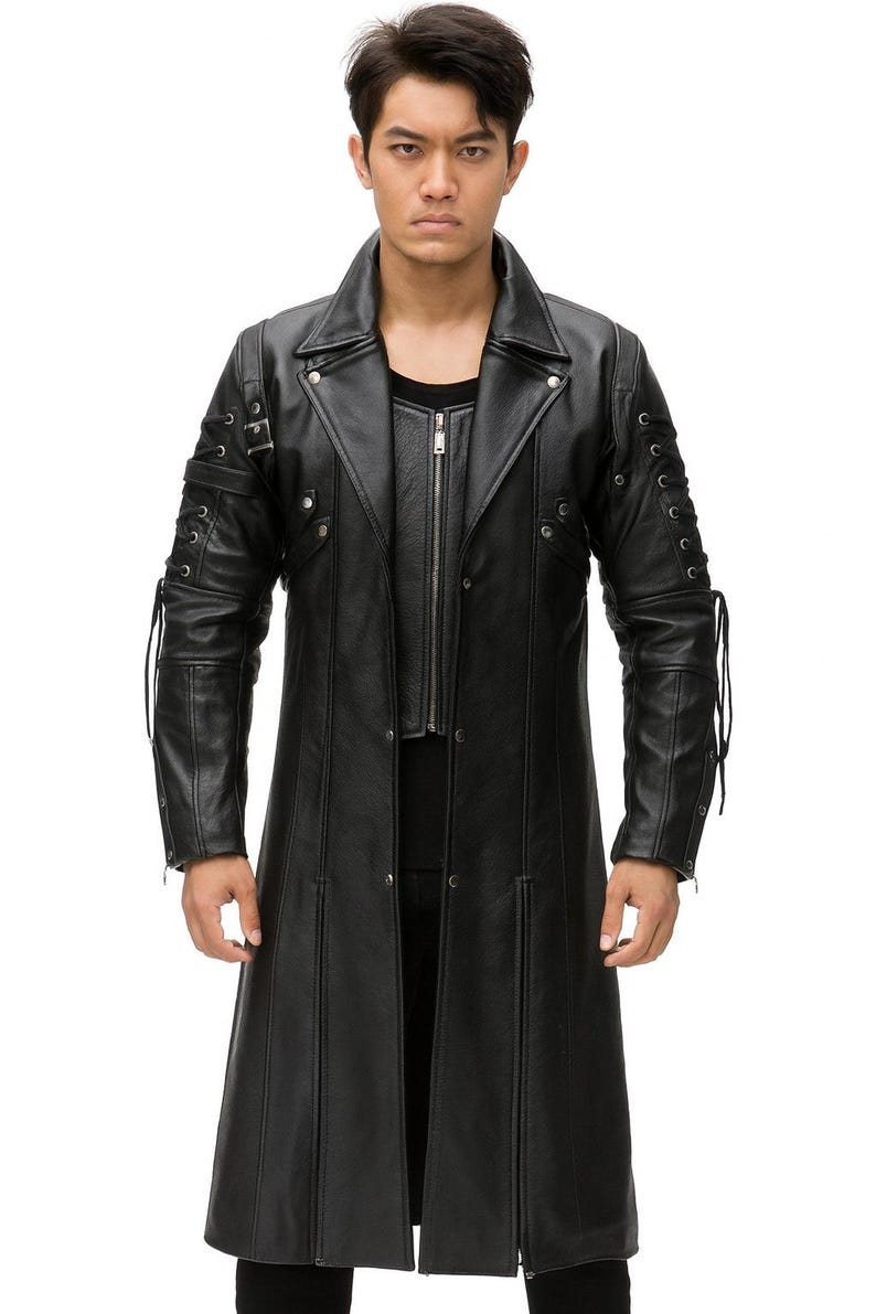 May include: A black leather trench coat featuring a wide lapel collar, a front zipper closure, and long sleeves with decorative side lacing details. The coat has a structured fit with vertical paneling and silver-toned metal hardware accents.