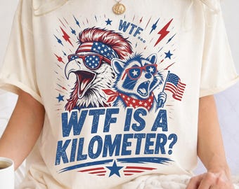 Camiseta "¿Qué demonios es un kilómetro?", divertida camiseta patriótica de águila y mapache, camiseta con meme del 4 de julio de EE. UU., regalo del 250 aniversario de la independencia de Estados Unidos.