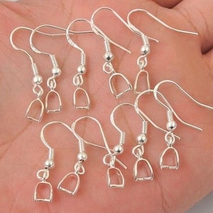 May include: A set of ten silver earring hooks with a small ball at the top and a loop at the bottom. The hooks are designed for attaching charms or other jewelry components.