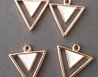 May include: Four gold-tone triangle charms with white enamel accents. Each charm has a loop at the top for attaching to jewelry.