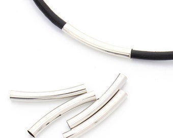 May include: A silver metal necklace with a black leather cord and four extra silver metal connector pieces.