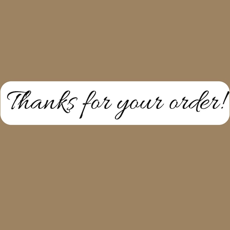 May include: A rectangular white sticker with rounded corners featuring the black cursive text Thanks for your order! centered on the surface. The sticker is presented against a solid, plain, light brown background color.