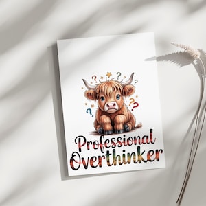 May include: A white rectangular print featuring a fluffy brown Highland cow illustration with small stars and colorful question marks surrounding its head. Below the cow, the text Professional Overthinker is written in a bold, dark font.