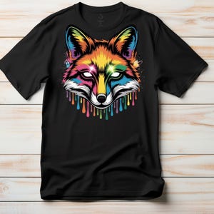 May include: Black t-shirt featuring a vibrant, colorful fox head design. The fox's face is a mix of rainbow hues, with dripping paint effects. The design includes white eyes and a detailed, artistic style.