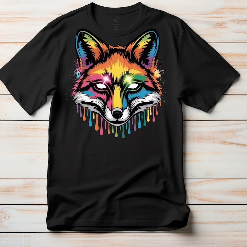 May include: Black t-shirt featuring a vibrant, colorful fox head design. The fox's face is a mix of rainbow hues, with dripping paint effects. The design includes white eyes and a detailed, artistic style.