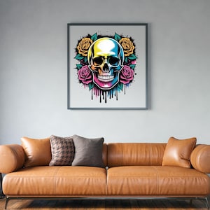 May include: Framed art print featuring a colorful skull design with yellow and pink roses. The skull has a gradient of colors, including yellow, blue, and pink. Black drips emanate from the bottom of the skull. The artwork is displayed above a brown leather sofa.
