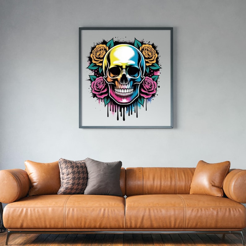 May include: Framed art print featuring a colorful skull design with yellow and pink roses. The skull has a gradient of colors, including yellow, blue, and pink. Black drips emanate from the bottom of the skull. The artwork is displayed above a brown leather sofa.