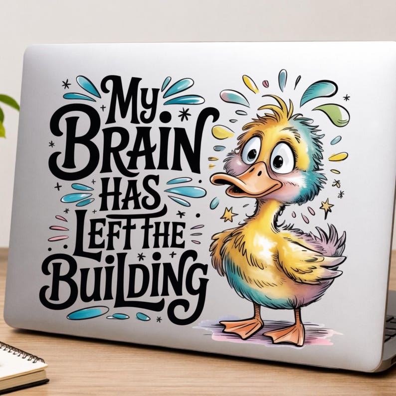 May include: A laptop decal featuring a cartoon duck with wide eyes and colourful feathers. The text reads, My Brain Has Left The Building, in bold black lettering. The design includes blue and yellow accents, stars, and water-like splashes.