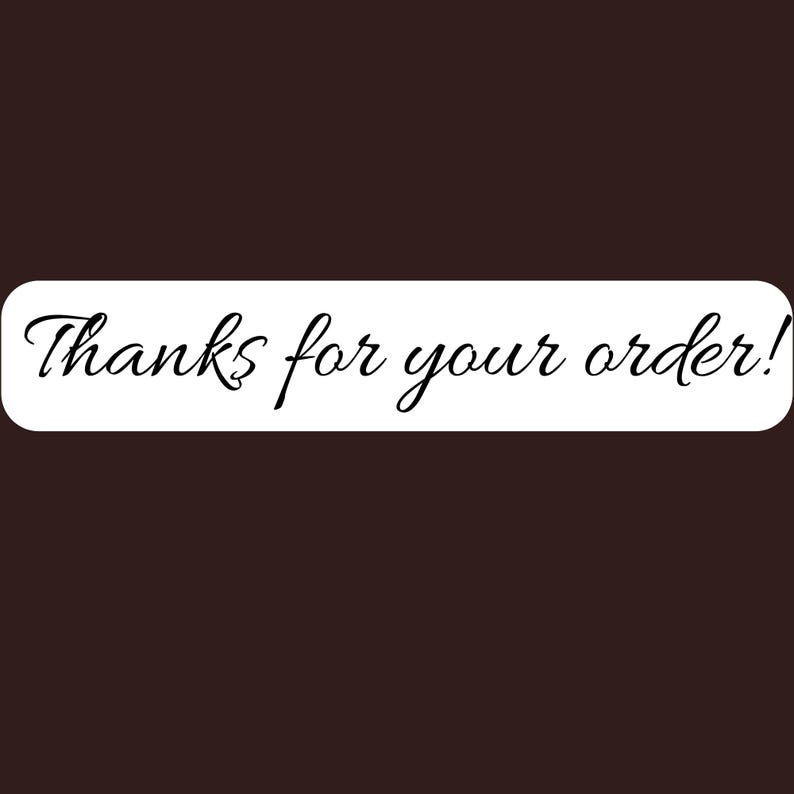 May include: A rectangular white sticker with rounded corners featuring the black cursive text Thanks for your order! centered on the surface. The sticker is presented against a solid dark brown background, highlighting the clear and legible lettering.