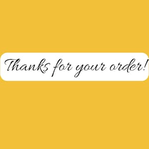 May include: A rectangular white sticker with rounded corners set against a solid mustard yellow background. The text Thanks for your order! is printed in a black, elegant, cursive script font centered horizontally within the white sticker area.