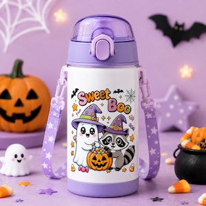 May include: A white water bottle with a purple lid and a purple carrying strap featuring a star pattern. The bottle displays a graphic of a ghost and a raccoon wearing witch hats, a jack-o'-lantern, and the text Sweet Boo in colorful letters.