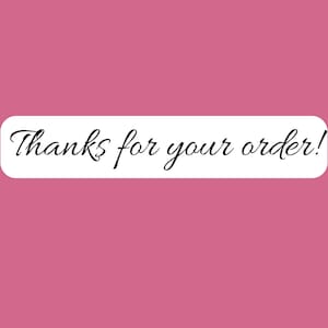 May include: A rectangular sticker with rounded corners featuring a solid pink background and a white center panel. The text Thanks for your order! is printed in a black, elegant, cursive script font across the center of the white panel.