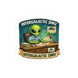 May include: A sticker featuring a green alien in a blue uniform sitting behind a desk. The alien is in an office setting with the words "Intergalactic DMV" above and below the image. A small Area 51 sign is visible.