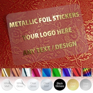 May include: A clear rectangular sticker with gold metallic text. The text reads "METALLIC FOIL STICKERS", "YOUR LOGO HERE", and "ANY TEXT / DESIGN". Below are sticker colour options, including white, clear, and black.