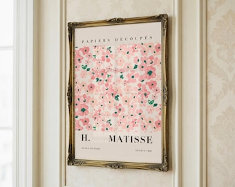 May include: A framed art print with a floral pattern in pink and green on a cream backdrop. The print is labelled "PAPIERS DÉCOUPÉS" and "H. MATISSE" in a gold ornate frame.