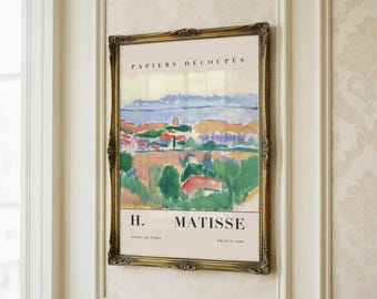 May include: A framed art print with a landscape painting in vibrant colors. The text "PAPIERS DÉCOUPÉS" is at the top. The artist's name, "H. MATISSE," is below the artwork, with "ECOLE DE PARIS" and "FRANCE 1890" also present.