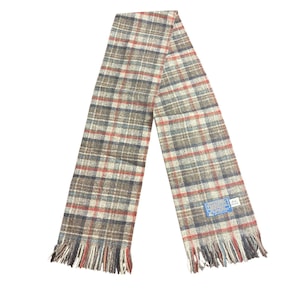 May include: A plaid scarf in shades of brown, red, and blue with fringed ends. The scarf is made of a woven fabric and features a classic pattern. A small tag is attached to the scarf.