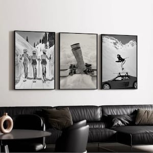 May include: A set of three framed black and white prints. The prints depict vintage ski scenes: skiers on a snowy slope, ski boots and skis in the snow, and a skier on top of a car with skis. The prints are displayed above a black leather sofa.