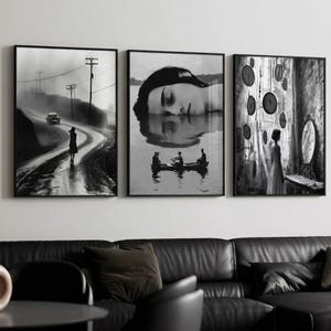 May include: Three framed black and white art prints. The left print shows a car on a winding road. The center print depicts a woman's face reflected in water. The right print features a woman in a room with clocks.