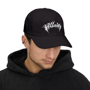 May include: A white ceramic mug with a black handle and the text "But First, Coffee" in a handwritten style. The mug is on a white surface.