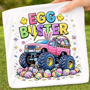 May include: White Easter-themed towel featuring a pink monster truck with large blue tires and the text "EGG BUSTER". The truck bed is filled with Easter eggs, and the design includes chicks, flowers, and bunny ears.