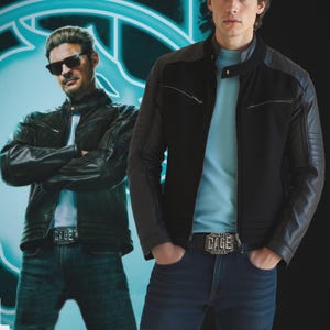 May include: Two men wearing black leather jackets and blue jeans. The jackets have a classic biker style with zippers and quilted shoulder details. Each man wears a belt with the word "CAGE" on the buckle. The background is a dark blue with a neon-style design.