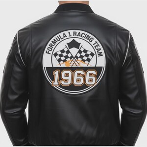 May include: Black leather jacket with white trim and a Formula 1 Racing Team patch on the back. The patch features checkered flags, the year 1966, and the team's name in a circular design.