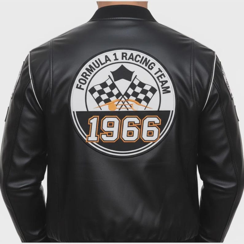 May include: Black leather jacket with white trim and a Formula 1 Racing Team patch on the back. The patch features checkered flags, the year 1966, and the team's name in a circular design.