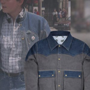May include: A two-tone denim jacket with a blue yoke and pockets, and a gray body. The jacket has two front pockets with button closures and a button-down front. The collar is a classic style, and the jacket has a paisley lining.