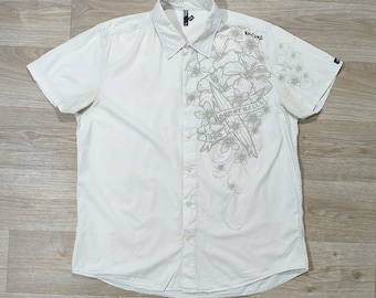 Camisa Rip Curl Tropical Floral • Logotipo gráfico bordado en color crema y caqui • Ropa de surf para la playa y el verano • Estilo costero Y2K • Ropa urbana oversize