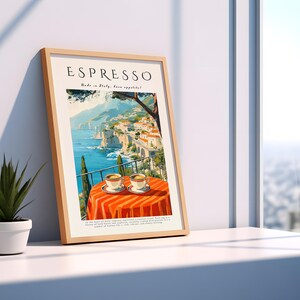 May include: A framed art print with the word "ESPRESSO" at the top. The print shows an Italian coastal scene with a table set for two, with espresso cups. The table is covered with an orange tablecloth.