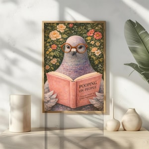 May include: A framed art print featuring a pigeon wearing glasses and reading a book titled "Pooping on People." The artwork has a floral background with a wooden frame. The book's subtitle reads "A Quiet Study in Urban Superiority."